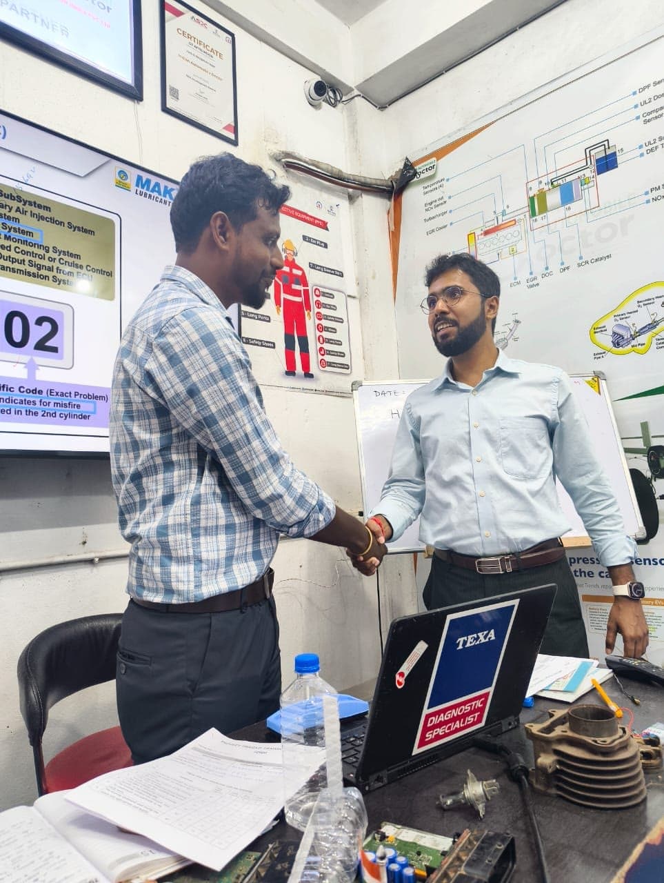 Student receiving a certificate from the IAD team