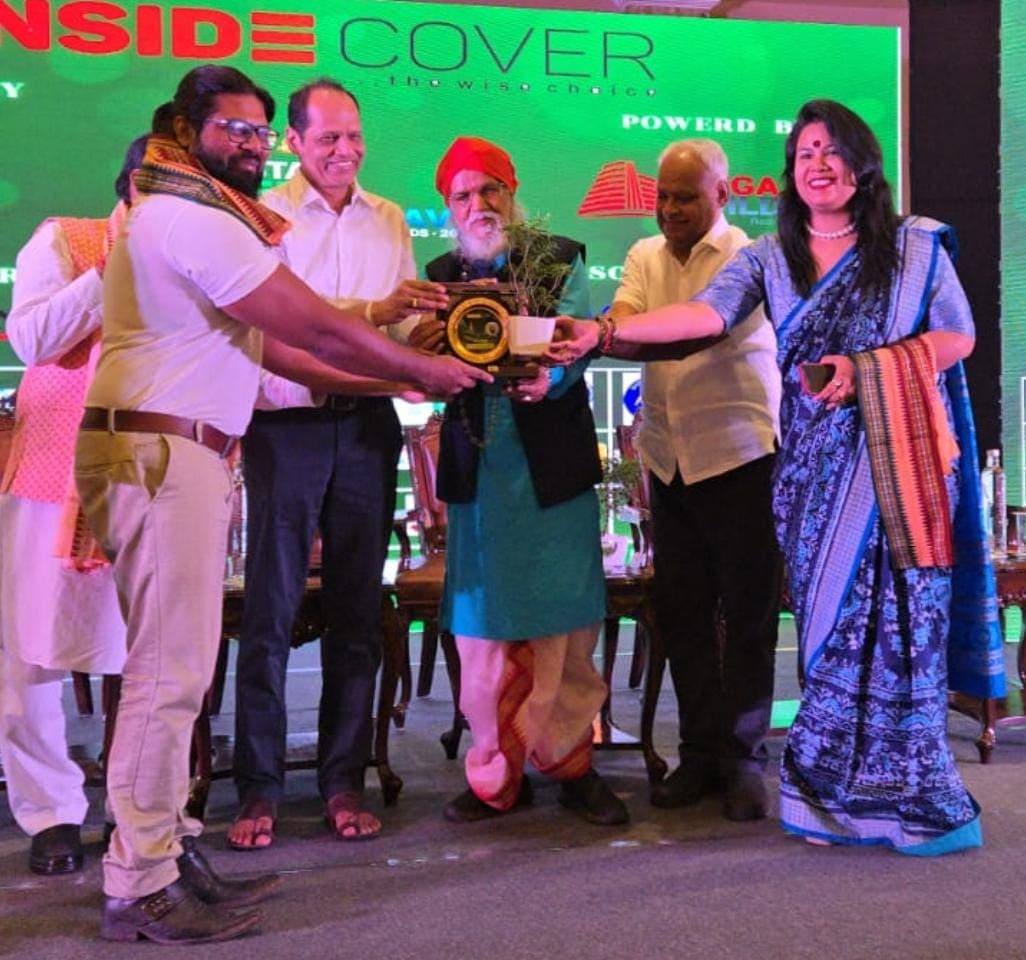 Founder receiving an award on stage at an Inside Cover event