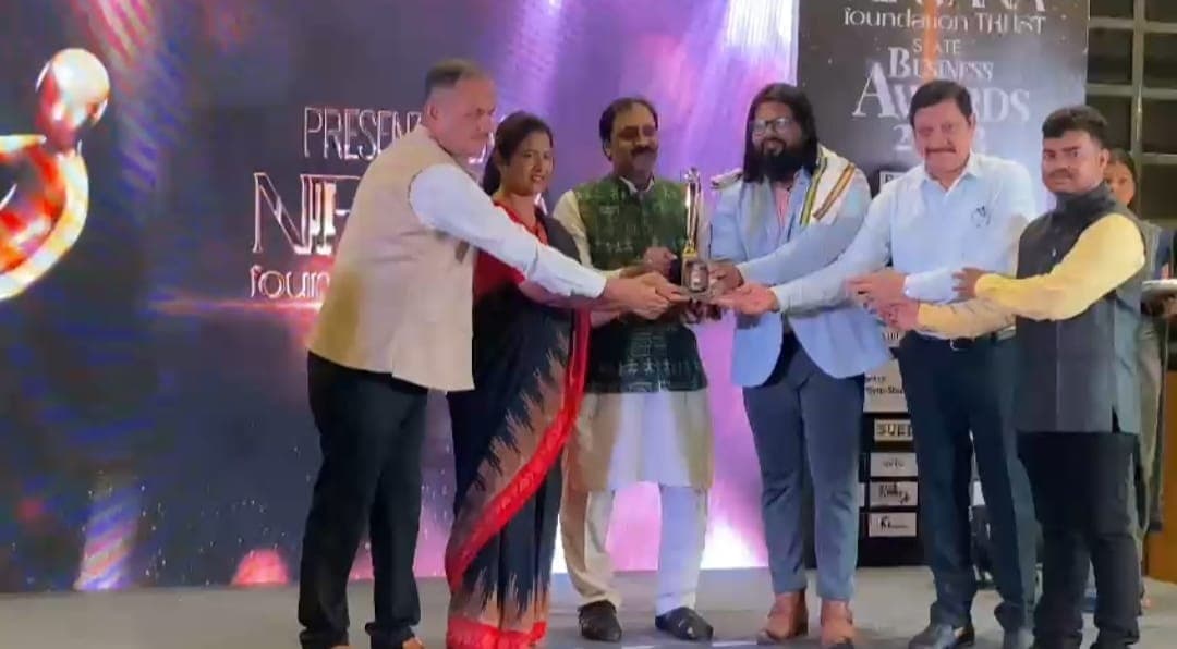 Founder receiving a trophy at the State Business Awards